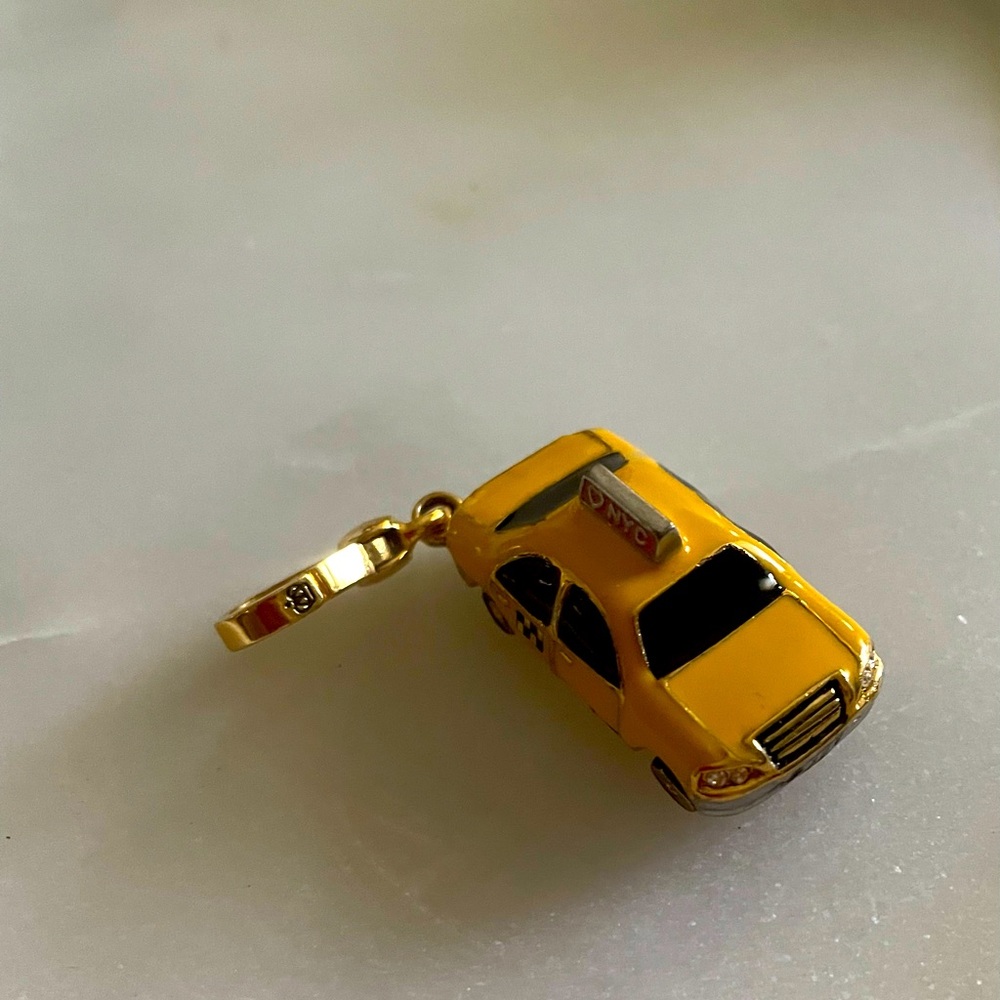 Authentic Juicy Couture Taxi Cab charm in original box in mint condition.